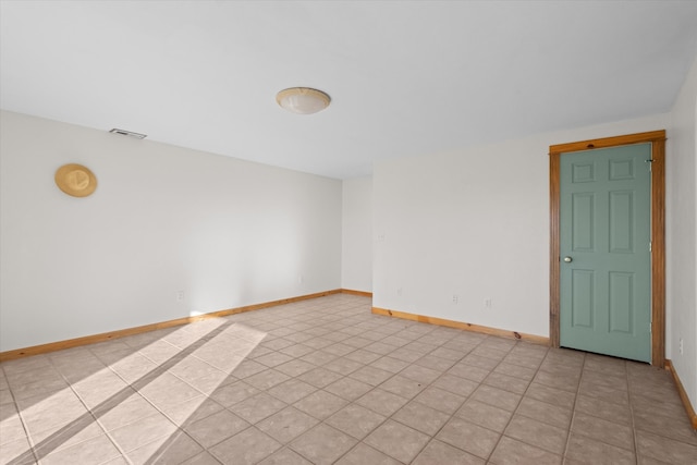 spare room featuring light tile patterned floors