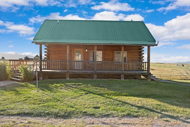 cabin featuring a front lawn, a porch, and a rural view