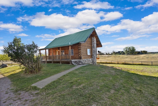 exterior space featuring a front lawn and a rural view