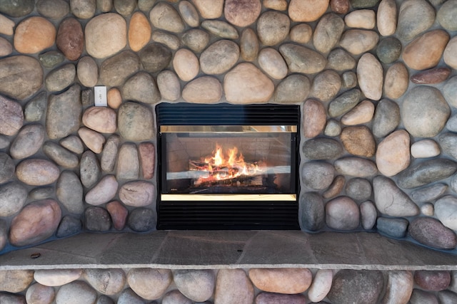 interior details featuring a stone fireplace