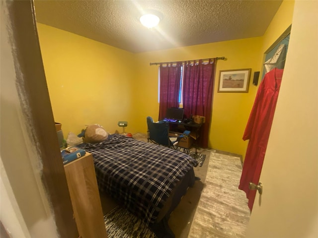 2417 S 3rd St W, Missoula, MT 59801 - bedroom with wood finished floors and a textured ceiling