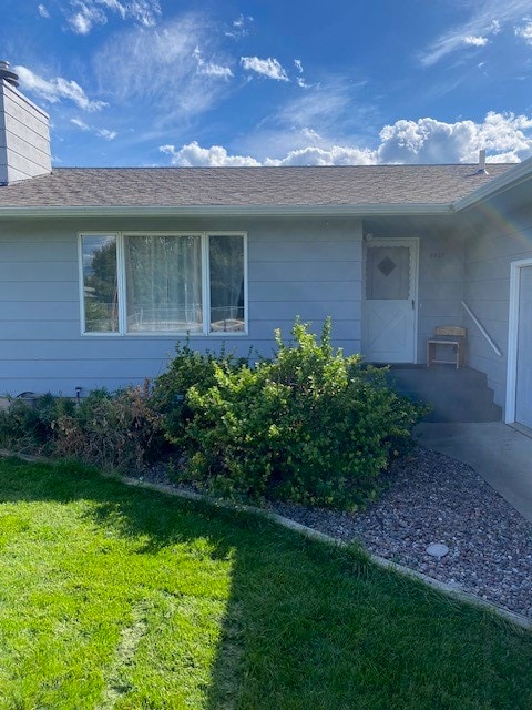 doorway to property with a yard