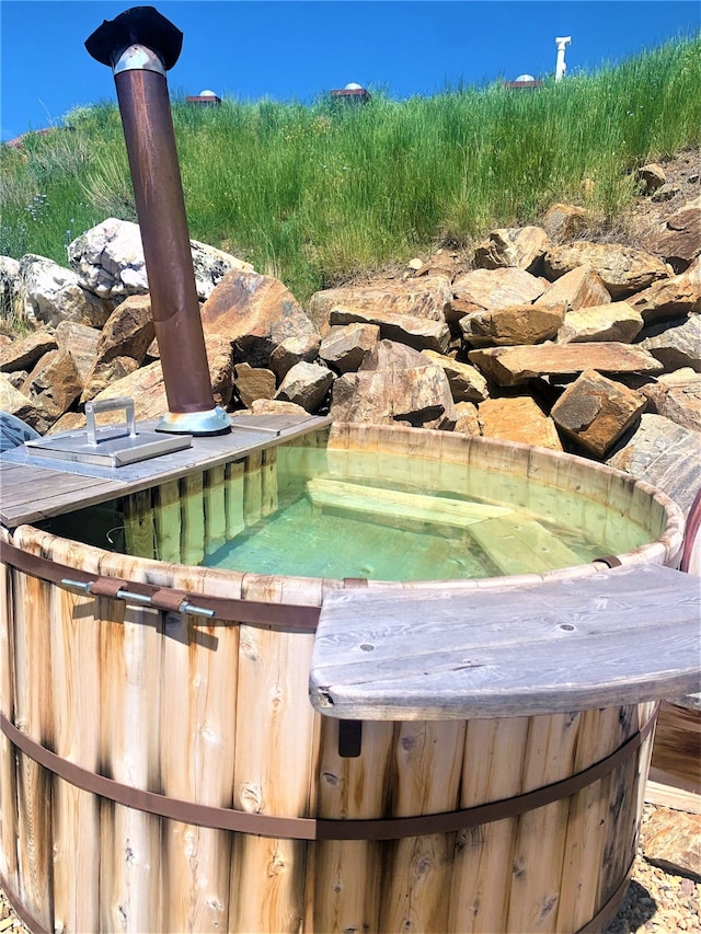 view of swimming pool with a hot tub