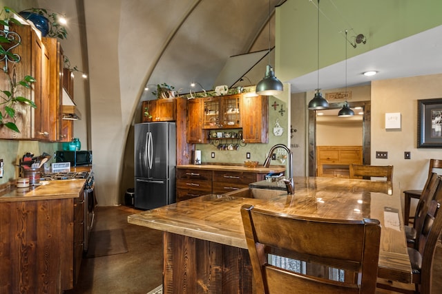 kitchen featuring decorative light fixtures, appliances with stainless steel finishes, backsplash, and sink