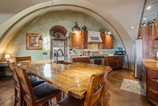 dining space with lofted ceiling and sink