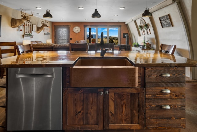 bar featuring pendant lighting, dark brown cabinets, dishwasher, wood counters, and sink