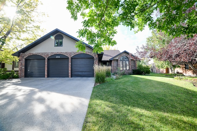 view of front facade with a garage and a front lawn