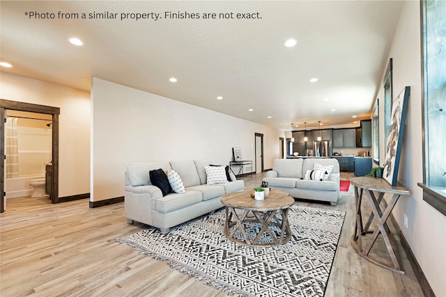 living room featuring a textured ceiling and light hardwood / wood-style floors