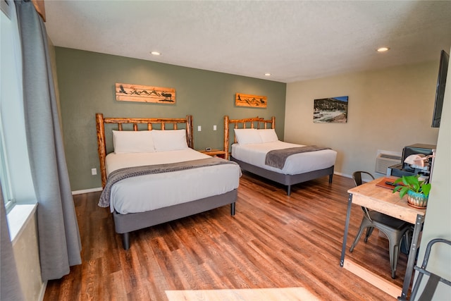 bedroom featuring wood-type flooring and a textured ceiling