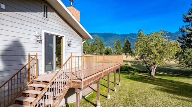 760 Trap Rd, Columbia Falls, MT 59912 - view of grassy yard featuring a deck with mountain view and stairs