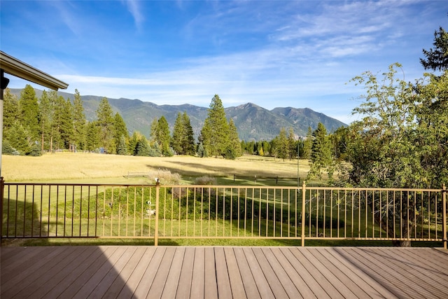 760 Trap Rd, Columbia Falls, MT 59912 - wooden deck featuring a mountain view and a yard