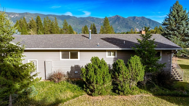 760 Trap Rd, Columbia Falls, MT 59912 - back of house featuring a mountain view and a chimney