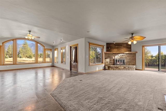 760 Trap Rd, Columbia Falls, MT 59912 - unfurnished living room featuring ceiling fan, a fireplace, and lofted ceiling