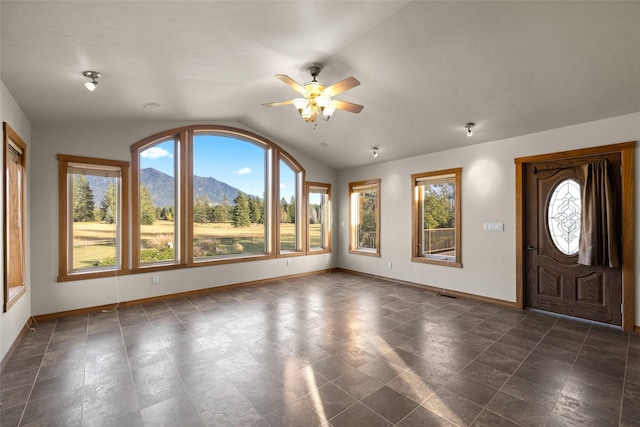 760 Trap Rd, Columbia Falls, MT 59912 - foyer entrance with vaulted ceiling, a ceiling fan, and a mountain view