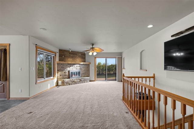 760 Trap Rd, Columbia Falls, MT 59912 - living area featuring ceiling fan, carpet, a stone fireplace, and recessed lighting