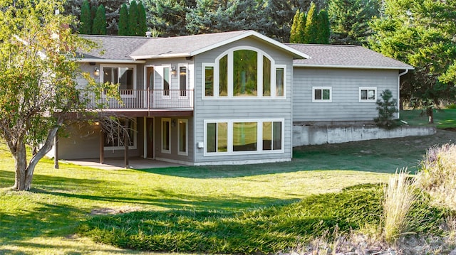 760 Trap Rd, Columbia Falls, MT 59912 - back of property with a patio area, a yard, a wooden deck, and a shingled roof