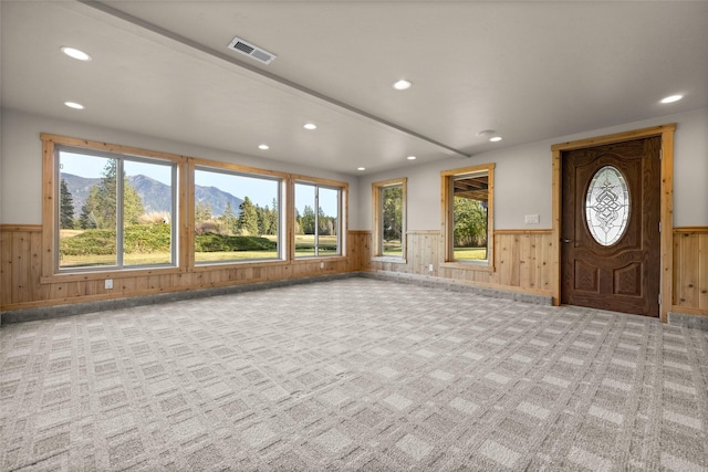 760 Trap Rd, Columbia Falls, MT 59912 - carpeted entrance foyer with a wainscoted wall, recessed lighting, wood walls, and a mountain view