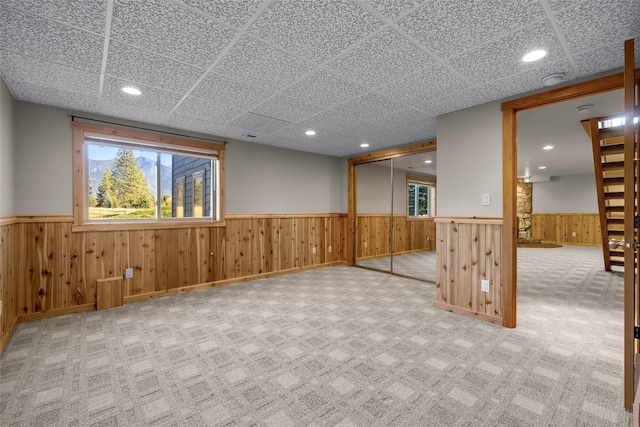 760 Trap Rd, Columbia Falls, MT 59912 - below grade area with wainscoting, carpet floors, recessed lighting, and a paneled ceiling