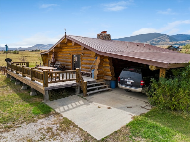 view of front of home featuring a carport and a deck with mountain view