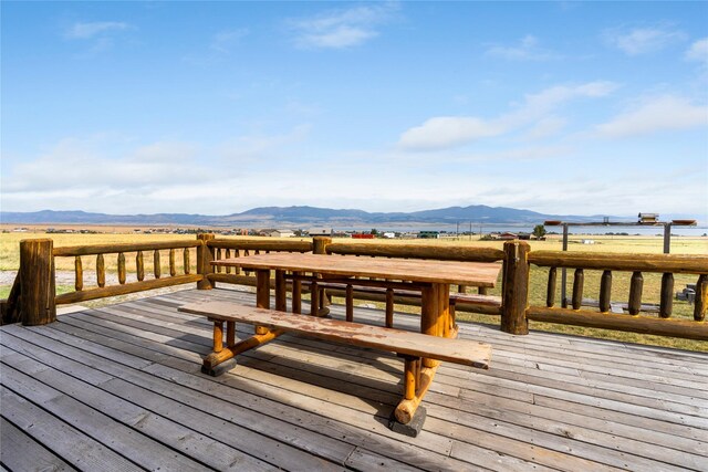 wooden terrace featuring a mountain view and a rural view