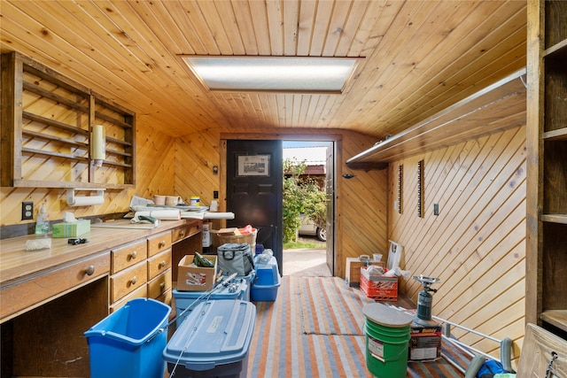 interior space with wood ceiling, wooden walls, and vaulted ceiling