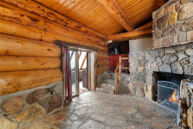 unfurnished living room featuring rustic walls, a warm lit fireplace, wood ceiling, and lofted ceiling with beams