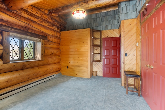 interior space with beam ceiling, a baseboard radiator, wooden walls, carpet, and wooden ceiling