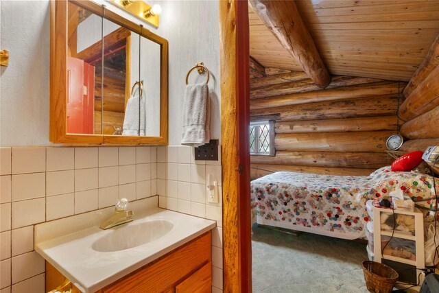 bathroom with vaulted ceiling with beams, wooden ceiling, vanity, and rustic walls