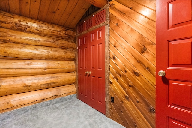 hall with wooden ceiling, carpet flooring, and vaulted ceiling