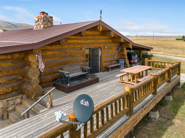 wooden terrace featuring a rural view and a mountain view