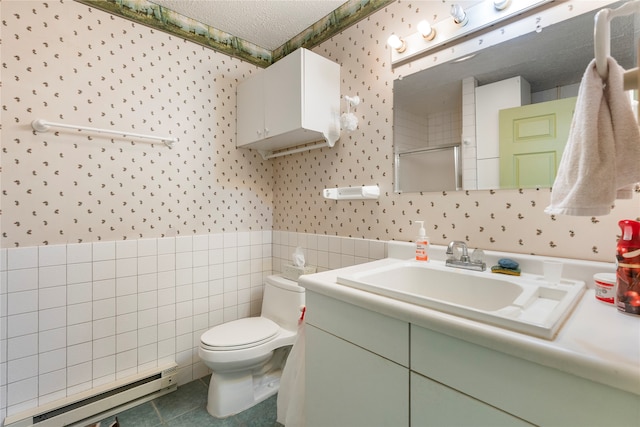 bathroom featuring vanity, a textured ceiling, tile patterned flooring, toilet, and a baseboard heating unit