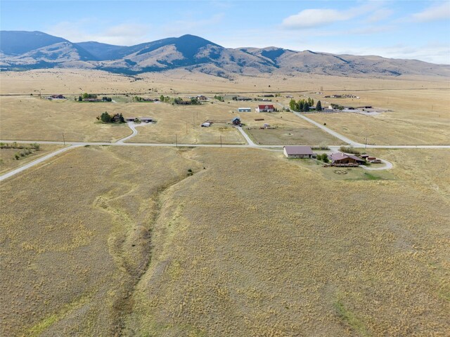 birds eye view of property featuring a mountain view and a rural view