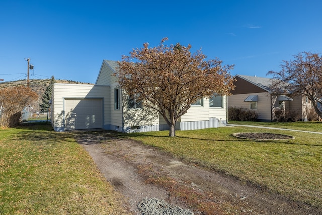 view of front of property with a garage and a front yard