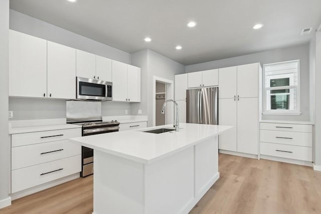 304 Trailview Way, Whitefish, MT 59937 - kitchen featuring stainless steel appliances, light wood finished floors, light countertops, white cabinets, and recessed lighting