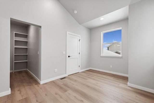 304 Trailview Way, Whitefish, MT 59937 - unfurnished bedroom featuring light wood-style flooring, lofted ceiling, and recessed lighting