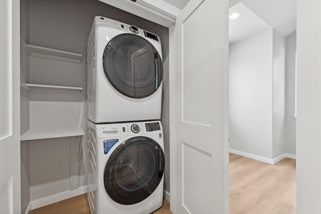 304 Trailview Way, Whitefish, MT 59937 - washroom featuring stacked washing machine and dryer, light wood-style flooring, and recessed lighting