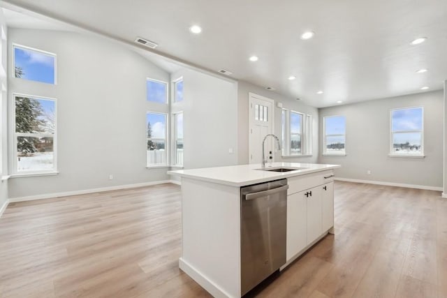 304 Trailview Way, Whitefish, MT 59937 - kitchen with dishwasher, light wood-type flooring, recessed lighting, vaulted ceiling, and a center island with sink