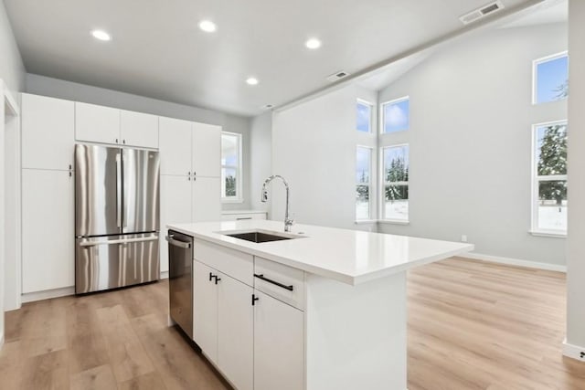304 Trailview Way, Whitefish, MT 59937 - kitchen with stainless steel appliances, light wood finished floors, light countertops, recessed lighting, and a center island with sink