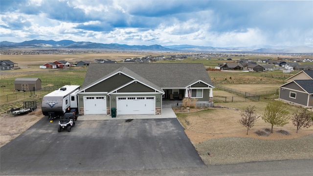 view of front facade featuring a garage and a mountain view