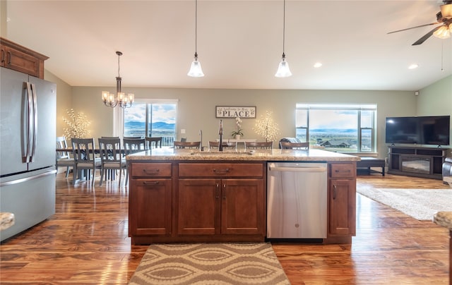 kitchen with dark hardwood / wood-style flooring, sink, stainless steel appliances, and a wealth of natural light