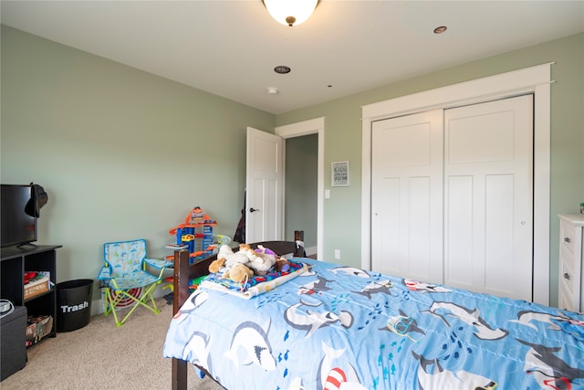 bedroom featuring light colored carpet and a closet