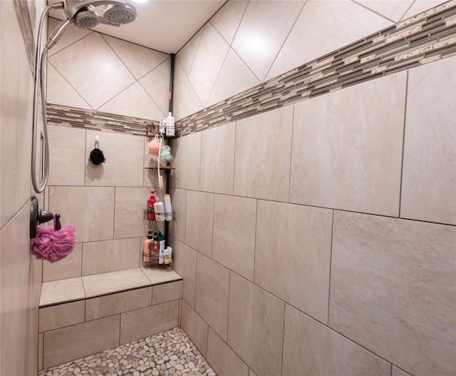 bathroom with a tile shower