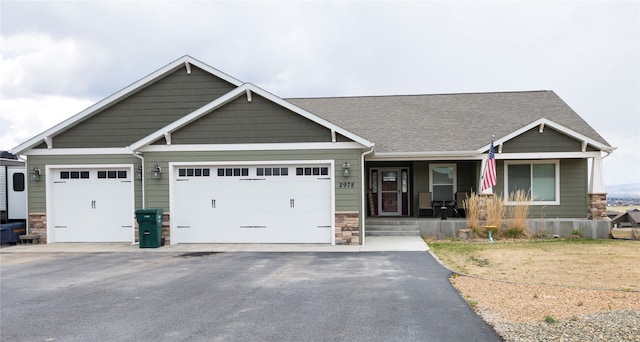 craftsman-style home featuring a garage and covered porch