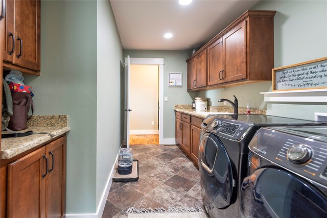 washroom featuring separate washer and dryer, cabinets, and sink