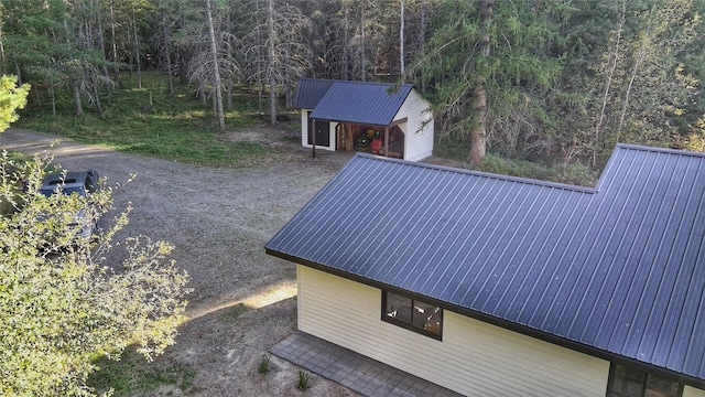drone / aerial view featuring a wooded view