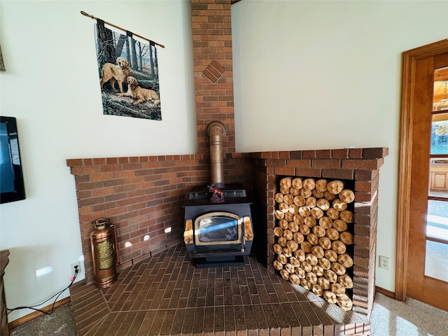 room details featuring a wood stove and baseboards