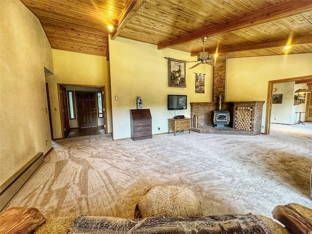 carpeted living room with a baseboard heating unit, beam ceiling, a wood stove, and wood ceiling