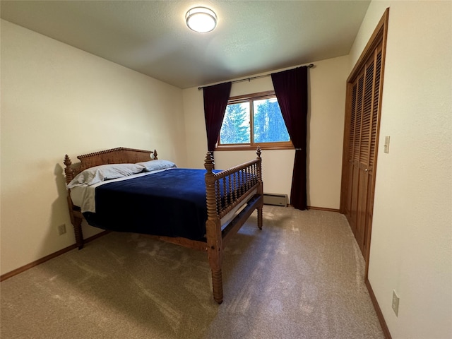 bedroom with carpet, a baseboard radiator, and baseboards