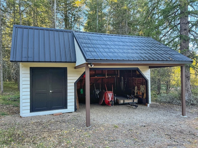 view of outbuilding with a carport and an outdoor structure