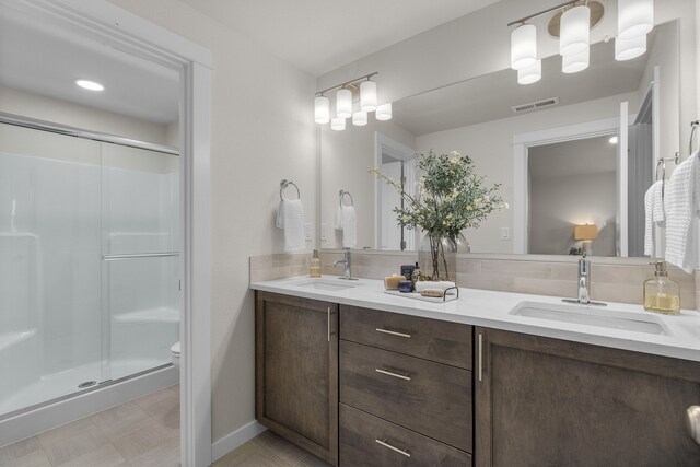 bathroom featuring vanity, toilet, and an enclosed shower